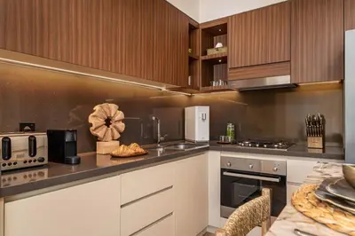 a kitchen with wooden cabinets and a counter top at Seraya Residences at Marina Yacht Club - Vida Marina in Dubai
