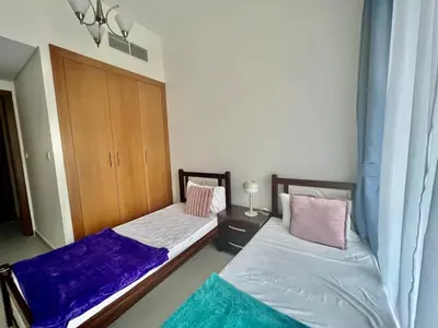 two beds sitting next to each other in a room at Al Karama close to subway in Dubai