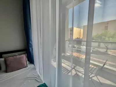 a bedroom with a window with a view of a street at Al Karama close to subway in Dubai