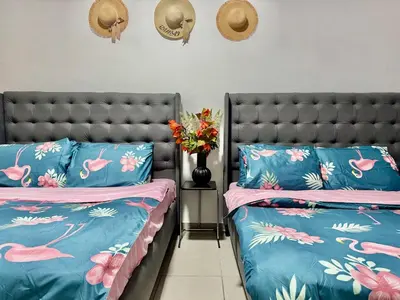 two beds in a room with blue and pink at Mina Road AL Thayer in Dubai