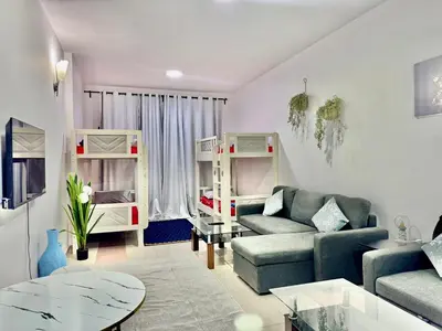 a living room with a couch and a bed at Mina Road AL Thayer in Dubai