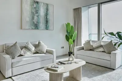 a living room with two couches and a coffee table at Downtown Luxury - 4 Minutes Walk to Dubai Mall & Burj Khalifa in Dubai