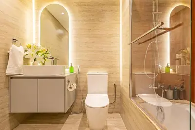 a bathroom with a toilet and a sink and a tub at Classy Studio in the Heart of Greens in Dubai