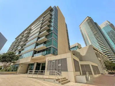 a tall building with two tall buildings at Elegant 1-Bedroom Apartment in Dubai Marina in Dubai