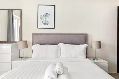 a bedroom with a bed with two feet on it at Elegant 1-Bedroom Apartment in Dubai Marina in Dubai