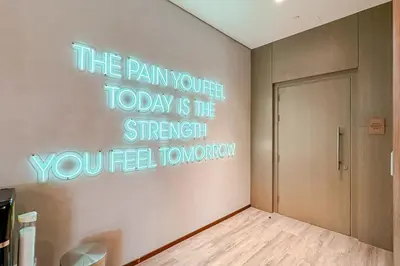 a room with a sign that reads the pain your today is the strength you feel at Central Park Building, City Walk - 1BR Sophisticated Apartment in Dubai