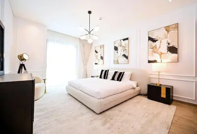 a white living room with a bed and a couch at Central Park Building, City Walk - 1BR Sophisticated Apartment in Dubai