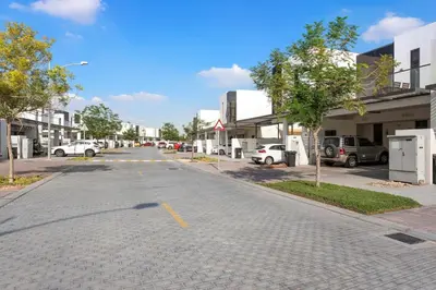 an empty street with cars parked in a parking lot at Elegant 3BR Villa with Access to Pool & Gym in Dubai