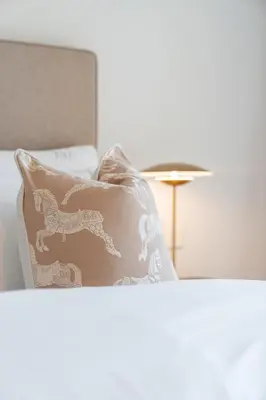 a bed with a pillow with a dog on it at Modern 1BR Steps from Burj AlArab Madinat Jumeirah By AYA Boutique in Dubai