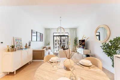 a living room with a table and chairs at Modern 1BR Steps from Burj AlArab Madinat Jumeirah By AYA Boutique in Dubai