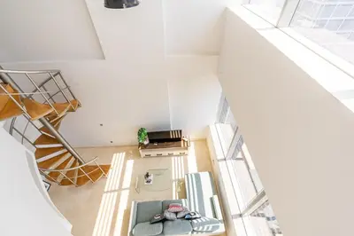 an overhead view of a living room with a staircase at Chic Urban Loft SkyGardens DIFC, Dubai in Dubai