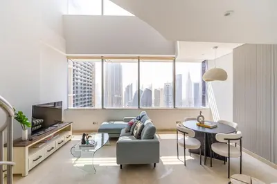 a living room with a couch and a table at Chic Urban Loft SkyGardens DIFC, Dubai in Dubai