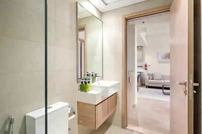 a bathroom with two sinks and a mirror at VayK - Modern 1BR with Spacious Terrace in Dubai