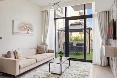 a living room with a couch and a table at VayK - Modern 1BR with Spacious Terrace in Dubai