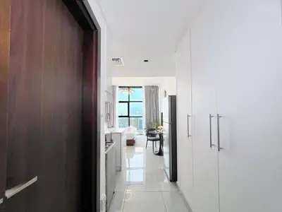 a hallway with a kitchen and a living room at Modern Studio with Stunning City Views in Dubai