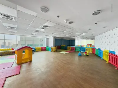 a large room with a playroom with colorful play equipment at Spacious Studio - 10 min drive to Burj Khalifa in Dubai