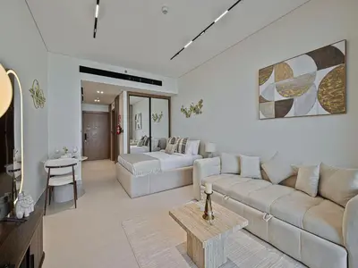a living room with a couch and a table at Daniels Studio with Private Jacuzzi & Canal View in Dubai