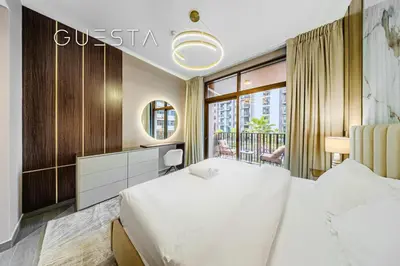 a hotel room with a large bed and a window at Kensington Waters, MBR City, Dubai in Dubai