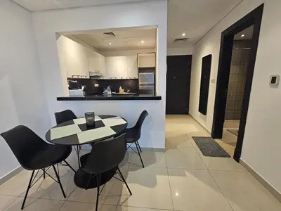 a kitchen and dining room with a table and chairs at Dubai Silverene Tower with large balcony and high floor Marina views in Dubai