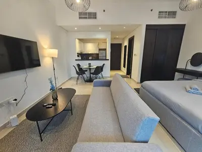 a living room with a couch and a table at Dubai Silverene Tower with large balcony and high floor Marina views in Dubai