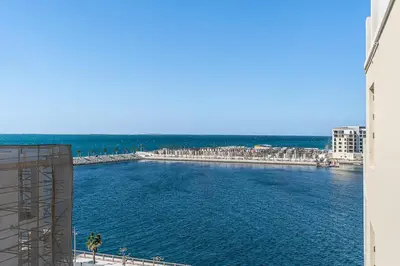 a view of a body of water from a building at Stylish 1BR Port De La Mer Escape with Beach Access in Dubai