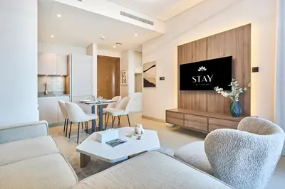 a living room with a couch and a tv at STAY BY LATINEM Luxury 1BR Holiday Home CVR A1814 near Burj Khalifa in Dubai