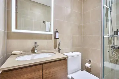 a bathroom with a sink and a toilet and a shower at STAY BY LATINEM Luxury 1BR Holiday Home CVR A1814 near Burj Khalifa in Dubai