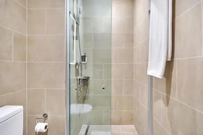 a bathroom with a shower with a glass door at STAY BY LATINEM Luxury 1BR Holiday Home CVR A1814 near Burj Khalifa in Dubai