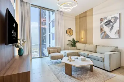 a living room with a couch and a table at STAY BY LATINEM Luxury 1BR Holiday Home CVR A1814 near Burj Khalifa in Dubai