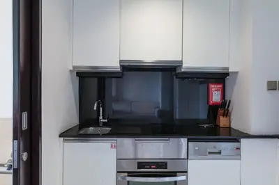 a kitchen with white cabinets and a sink at Amazing Dubai Marina Studio Pool Beach Sea View in Dubai