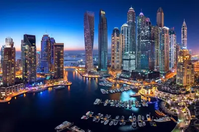 a view of a city at night at Amazing Dubai Marina Studio Pool Beach Sea View in Dubai