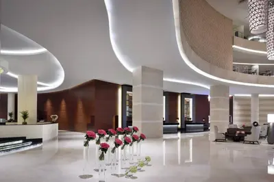 a lobby with red roses in vases on the floor at Amazing Dubai Marina Studio Pool Beach Sea View in Dubai