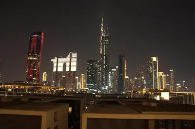 a city skyline at night with tall buildings at Luxury 1 Bedroom Burj Khalifa View Citywalk in Dubai