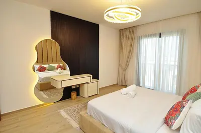 a bedroom with two beds and a sink and a mirror at Luxury 1 Bedroom Burj Khalifa View Citywalk in Dubai