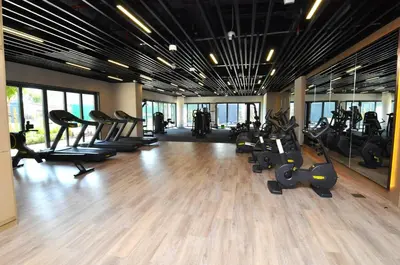 a gym with a bunch of treadmills and exercise bikes at Luxury 1 Bedroom Burj Khalifa View Citywalk in Dubai