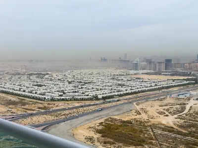 an aerial view of a city with buildings and a road at Damac Carson B Studio, Scenic & Serene Stay in Dubai