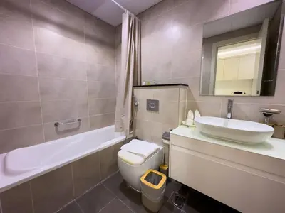 a bathroom with a sink and a toilet and a tub at Damac Carson B Studio, Scenic & Serene Stay in Dubai