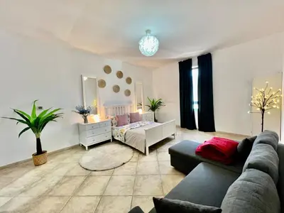 a living room with a couch and a bed at Motor City Shakespeare Circus in Dubai