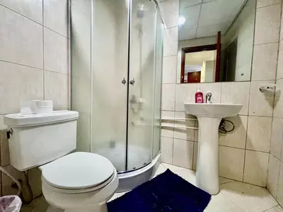 a bathroom with a shower and a toilet and a sink at Motor City Shakespeare Circus in Dubai