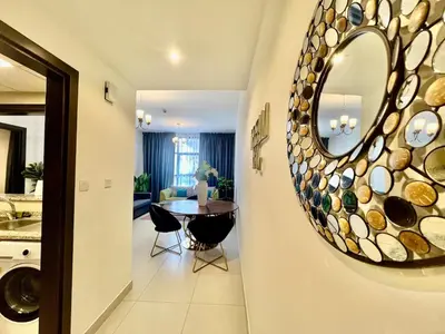 a kitchen and dining room with a mirror on the wall at Jaddaf Pool Gym Parking in Dubai