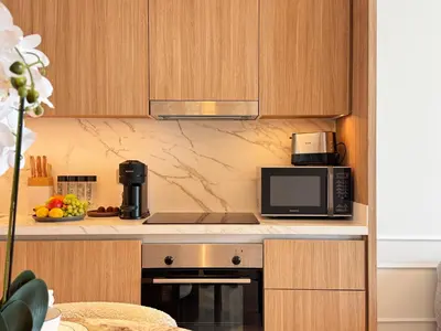 a kitchen with a microwave and a coffee maker at Luxury 2BR in Beach Vista With Stunning Palm Views in Dubai