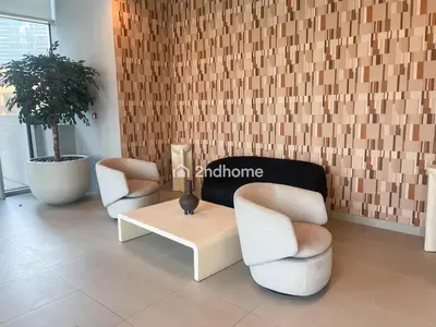 a lobby with two chairs and a table and a plant at Burj Khalifa view, 3 Bedroom, Maids Room, Forte in Dubai