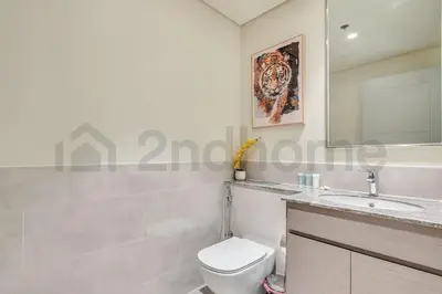a bathroom with a toilet and a sink and a mirror at Burj Khalifa view, 3 Bedroom, Maids Room, Forte in Dubai