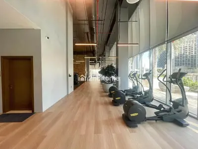 a gym with treadmills and ellipticals in a building at Burj Khalifa view, 3 Bedroom, Maids Room, Forte in Dubai