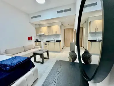 a room with a bed and a kitchen with a mirror at Sleep 3 Walk to ADCB metro in Dubai