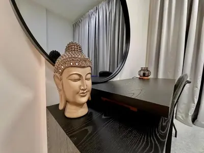 a bust of a head on a table with a mirror at Sleep 3 Walk to ADCB metro in Dubai