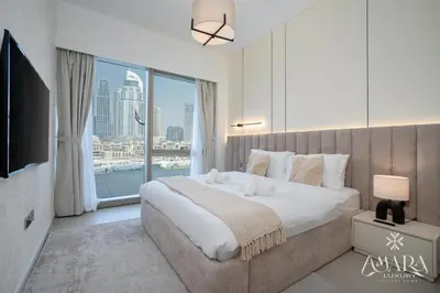 a bedroom with a large bed and a large window at Grande Luxury, Burj Khalifa & Fountain View in Dubai