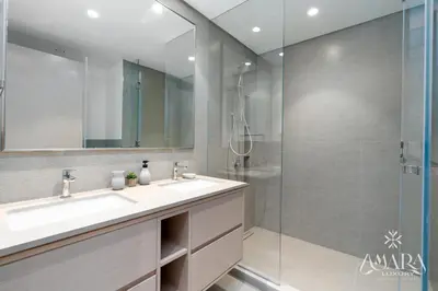 a bathroom with a sink and a glass shower at Grande Luxury, Burj Khalifa & Fountain View in Dubai