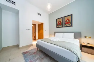 a bedroom with a large white bed in a room at Stylish Old Town 1 Bed Plus Maids with Private Garden in Dubai
