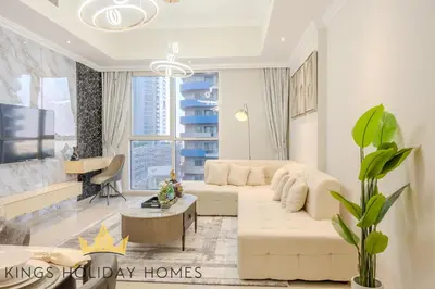 a living room with a white couch and a table at Royal Suites Dunya Tower Burj Khalifa ST in Dubai